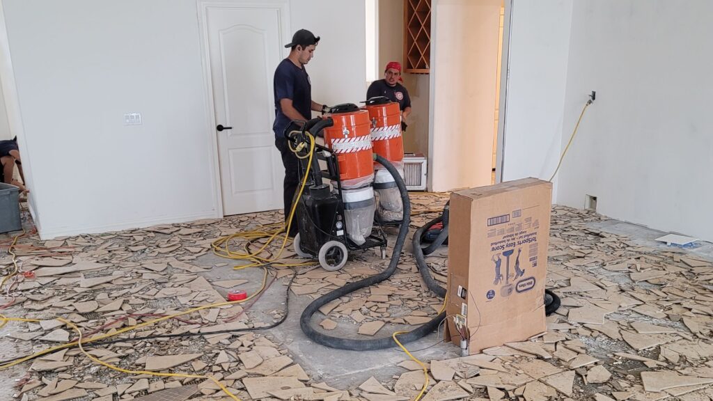 professionals using machine for tile removal