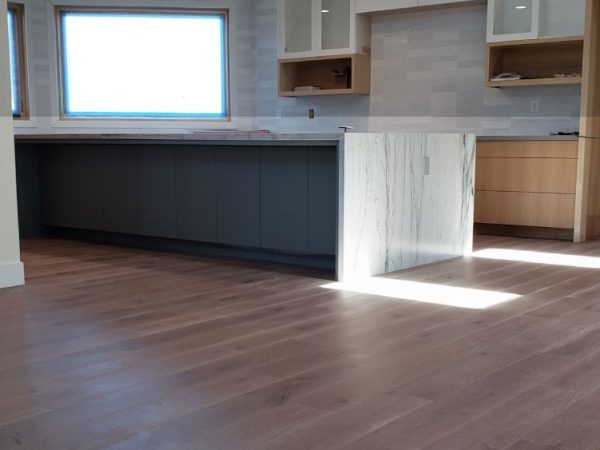 A room showcasing beautiful vinyl flooring with a dark wood-like design